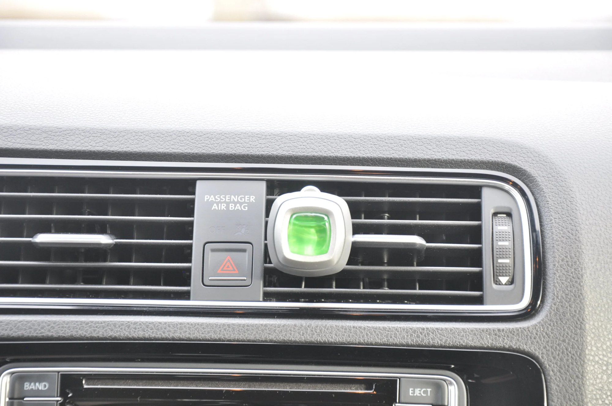 Car vent clip air freshener mounted in a vehicle vent — industrial design by Geoff LaCorte