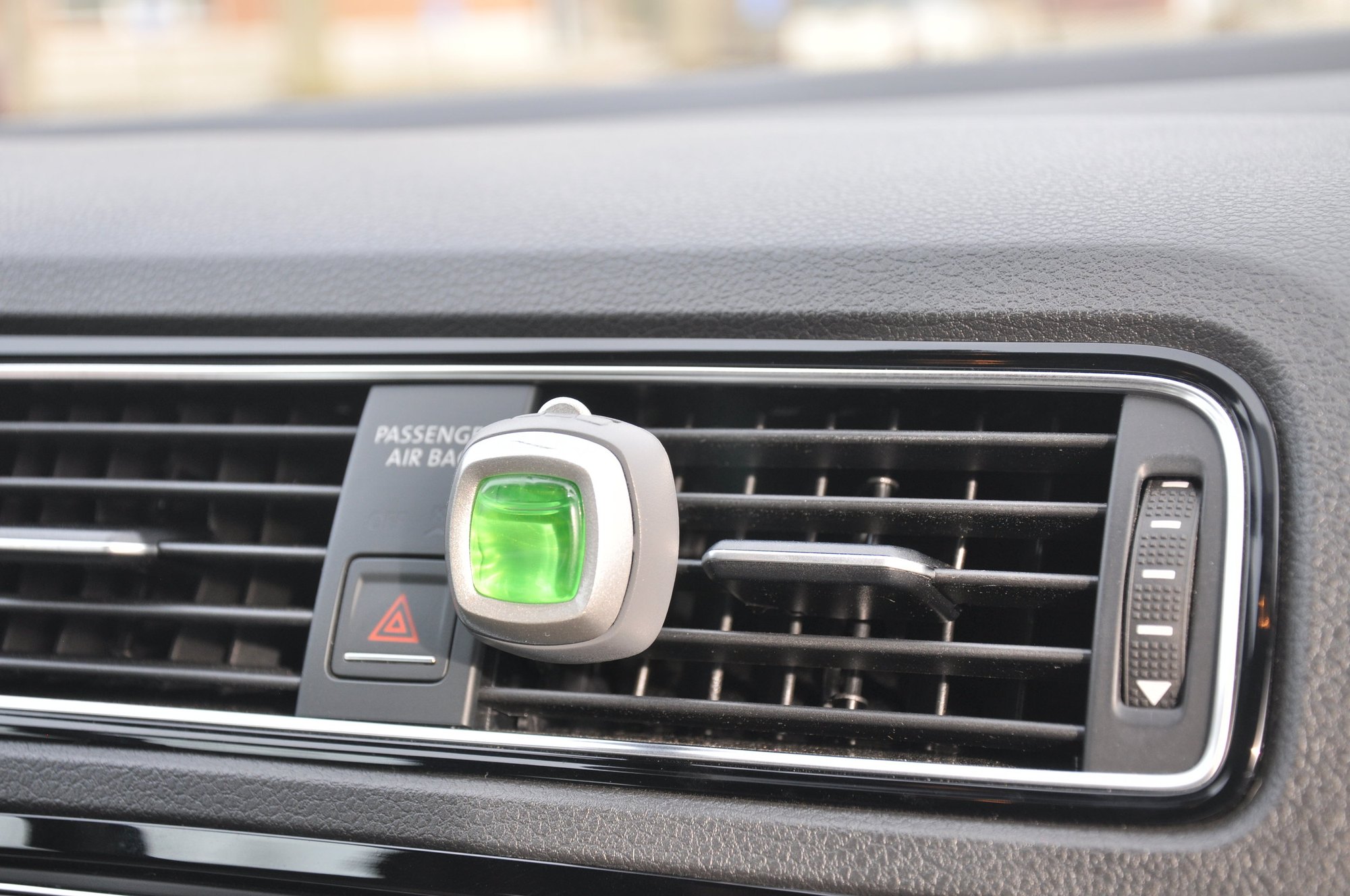 Car vent clip air freshener mounted in a vehicle vent — detail